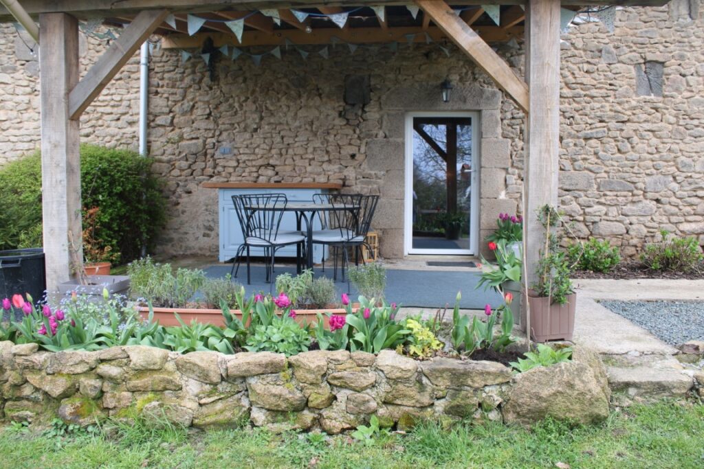 The undercover outdoor kitchen and dining area. Spring flowers in bloom