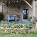 The undercover outdoor kitchen and dining area. Spring flowers in bloom